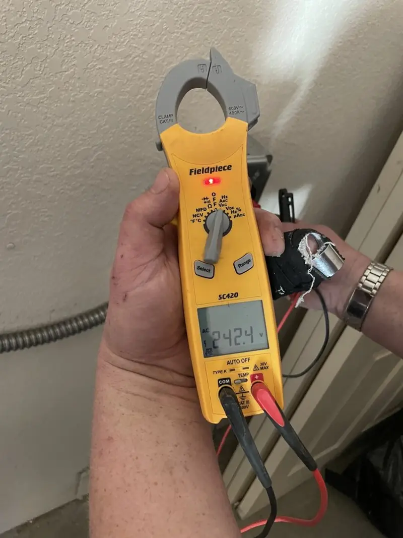 Voltage testing with clamp meter during Recessed Lighting Installation in Tequesta